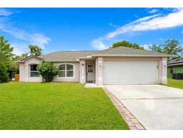 Charming single-Gathering home with a well-manicured lawn and a two-car garage in a peaceful neighborhood at 1116 Adirondack St, Deltona, FL 32725
