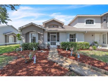 Charming townhome with a meticulously landscaped front yard and a welcoming walkway at 14650 Laguna Beach Cir, Orlando, FL 32824