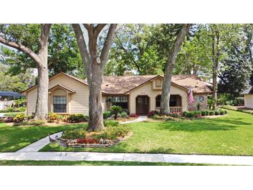 Charming single story home with mature landscaping and beautiful lawn at 1575 N Ridge Lake Cir, Longwood, FL 32750