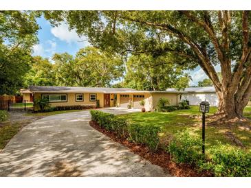 Charming single-story home with a well-maintained lawn and mature trees along an extended driveway at 502 Oak Ln, Maitland, FL 32751