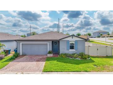 Charming single-story home with a well-manicured lawn and a cozy front entrance at 719 Tortugas St, Haines City, FL 33844