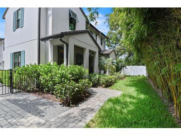 Charming home with lush landscaping, stone pathway, and privacy bushes at 1429 Indiana Ave, Winter Park, FL 32789