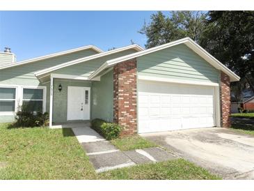 Charming one-story home with a two-car garage and well-maintained lawn at 2828 Whispering Way, Winter Park, FL 32792
