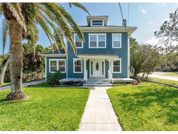 Charming two-story home with a landscaped lawn and inviting white-framed windows at 600 Bostwick Ave, Daytona Beach, FL 32118