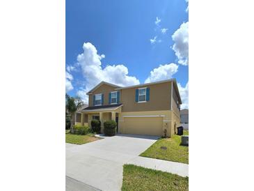 Charming two-story home featuring a well-maintained lawn and blue shutters, perfect for curb appeal at 651 Taft Dr, Davenport, FL 33837
