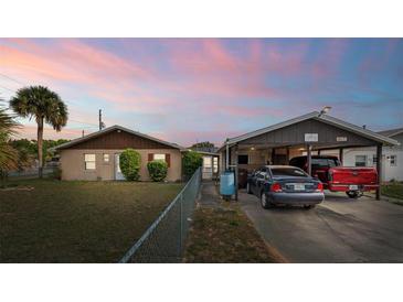 Charming single-story home with a well-maintained lawn, mature landscaping, and covered parking at 99 Rainbow Dr. # 4, Haines City, FL 33844
