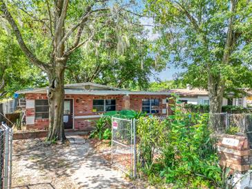 Charming single-story brick home with mature landscaping, gated yard, and inviting entryway at 1263 Dunbar St, Altamonte Springs, FL 32701
