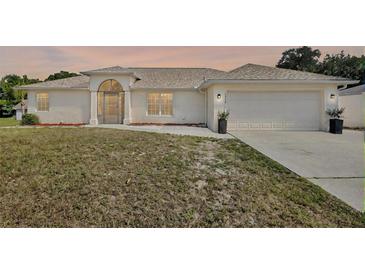 Charming single-story home featuring stucco siding and a two-car garage and a nice front yard at 1312 Catalina Blvd, Deltona, FL 32725