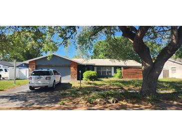 Charming single-story home with a two-car garage and mature landscaping at 1985 Japonica Rd, Winter Park, FL 32792