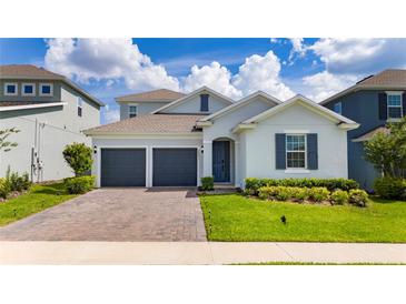 Charming single-Gathering home with a two-car garage and manicured lawn at 2591 Seagirt Way, Clermont, FL 34711