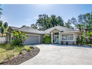 Charming home featuring a well-manicured lawn, an attached garage, and inviting curb appeal at 2623 Gables Dr, Eustis, FL 32726