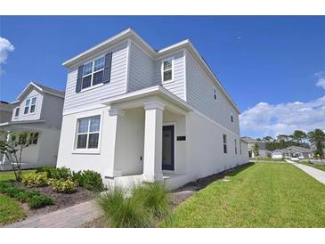 Charming two-story home with a well-maintained lawn and inviting front entrance at 3027 Addison Blvd, St Cloud, FL 34771