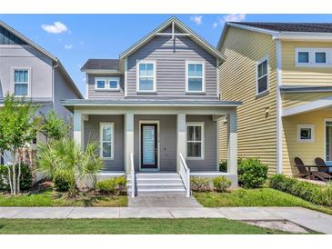 Charming two-story home featuring a welcoming front porch with classic columns and well-maintained landscaping at 13913 Hahn Ln, Orlando, FL 32827