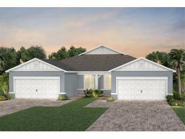 Charming single-story home featuring a symmetrical design, two-car garage, and neatly landscaped front yard at 2458 Cliff Way, St Cloud, FL 34771