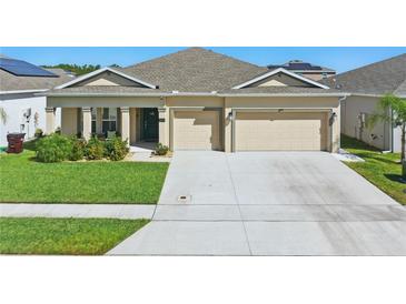 Charming single-Gathering home with well-manicured lawn, a two-car garage, and inviting curb appeal at 588 Hitch Loop, St Cloud, FL 34769