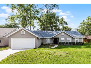 Charming single-story home with a well-maintained lawn and attached two-car garage at 717 Pine Ter, Altamonte Springs, FL 32714