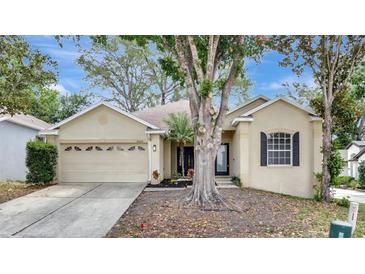 Charming single-story home featuring a manicured lawn, two-car garage, and inviting front entrance at 2468 Cimmaron Ash Way, Apopka, FL 32703