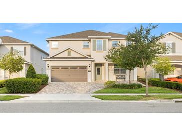 Charming two-story home featuring a well-manicured front yard and a two-car garage at 257 Auburn Ave, Kissimmee, FL 34747