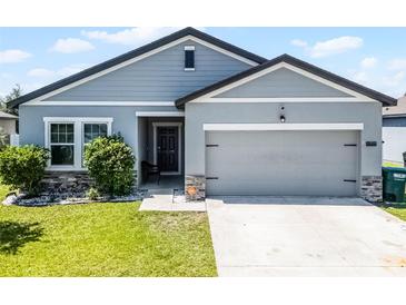 Charming single-Gathering home with well-manicured lawn and an attached two-car garage at 3519 Fernanda Dr, Deltona, FL 32738
