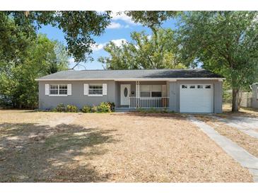 Charming single-story home featuring a well-maintained yard and attached garage at 439 Sunrise Ct, Orlando, FL 32803