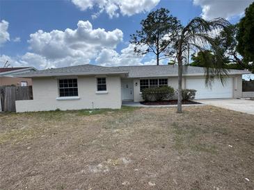 Charming single-story home with a well-manicured lawn and mature landscaping at 6624 Kristin Ct, Orlando, FL 32818