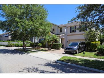 Beautiful two-story home with landscaped front yard, attached garage, and inviting curb appeal at 9005 Reflection Pointe Dr, Windermere, FL 34786