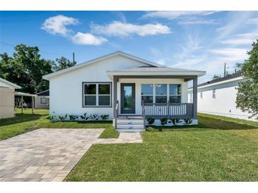 Charming one-story home with a welcoming front porch and well-manicured lawn at 1040 20Th St, Orlando, FL 32805