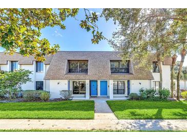 Charming townhome with manicured lawn and inviting blue front doors at 1210 Maury Rd # 3, Orlando, FL 32804