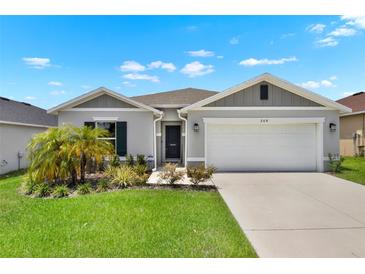 Charming single-Gathering home with a well-manicured lawn and a two-car garage in a suburban neighborhood at 208 Summerlin Ln, Haines City, FL 33844