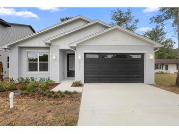 Charming single-story home featuring a modern exterior, neat landscaping, and an attached two-car garage at 2131 Brighton Ln, Orlando, FL 32817