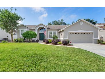 Charming home featuring a well-manicured lawn, tidy landscaping, and a two-car garage at 249 Mill Slough Rd, Oviedo, FL 32766