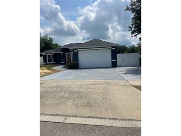 Charming single-story home with attached two-car garage and freshly painted driveway and walkway at 4843 Pierce Arrow Dr, Apopka, FL 32712