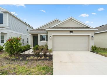 Charming single-story home featuring a two-car garage and well-maintained landscaping at 6834 Wilson Hammock Ave, Groveland, FL 34736