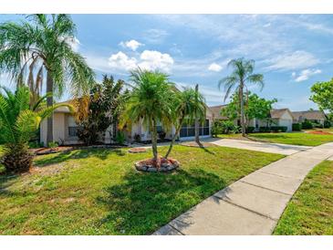 Beautiful single-Gathering home with meticulously kept lawn and mature tropical landscaping at 131 Country Creek Ln, Kissimmee, FL 34746