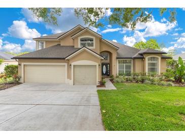 Charming home with a three-car garage and beautiful landscaping at 1837 Sweetwater West Cir, Apopka, FL 32712