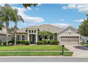 Charming single-story home with lush landscaping, stone accents, and a spacious three-car garage at 9843 Nokay Dr, Orlando, FL 32836