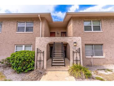 Inviting condo exterior featuring a charming entrance with stairs and well-maintained landscaping at 1177 Paseo Del Mar # D, Casselberry, FL 32707