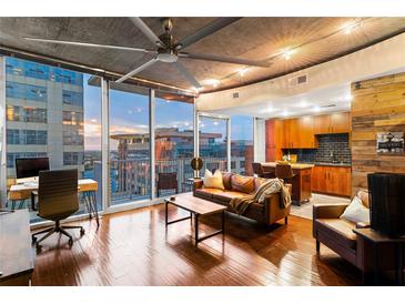 Inviting living room featuring modern decor, hardwood floors, and city views at 155 S Court Ave # 1608, Orlando, FL 32801