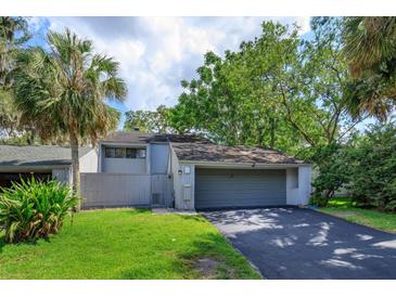 Charming home featuring a two-car garage, well-maintained lawn, and mature trees providing ample shade at 209 Sweet Gum Way, Longwood, FL 32779