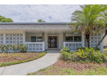 Inviting home entrance with decorative concrete screen, manicured landscaping, and a stylish front door at 2171 Chippewa Trl, Maitland, FL 32751