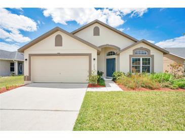 Charming single-story home with a well-manicured lawn, a two-car garage, and inviting curb appeal at 2541 Bobby Lee Ln, St Cloud, FL 34772