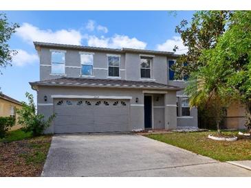 Two-story home featuring a neutral paint scheme, a two car garage, and simple landscaping at 2724 Amanda Kay Way, Kissimmee, FL 34744