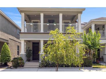 Charming two-story home features a double porch, neutral paint, and meticulously kept landscaping at 308 Michael Blake Blvd, Winter Springs, FL 32708