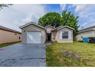 Charming single-story home featuring a one-car garage and well-maintained lawn at 5423 Blueberry Dr, Orlando, FL 32811