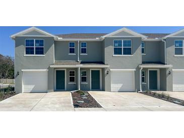 Modern townhouse featuring a one car garage and welcoming facade at 548 Zinfandel Dr, Daytona Beach, FL 32117