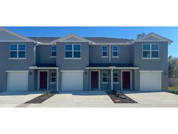 Newly constructed townhomes offer modern exteriors with individual garages and landscaped front yards at 552 Zinfandel Dr, Daytona Beach, FL 32117