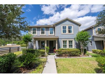 Charming two-story home featuring manicured landscaping, a walkway, and a welcoming facade at 6543 Orange Cream Aly, Winter Garden, FL 34787