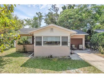 Charming single-story home featuring a cozy front porch and well-maintained lawn with mature trees at 849 Driver Ave, Winter Park, FL 32789