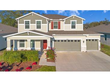 Charming two-story home with a well-manicured lawn, two-car garage, and beautiful landscaping at 10249 Spring Lake Dr, Clermont, FL 34711