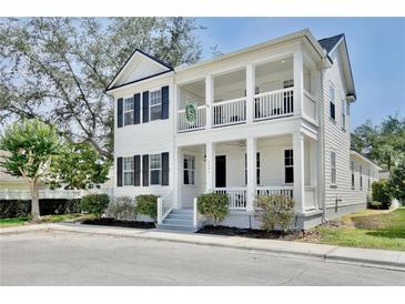 Charming two-story home boasting double porches, white siding, and black shutters, creating inviting curb appeal at 1101 Rush Ct, Celebration, FL 34747